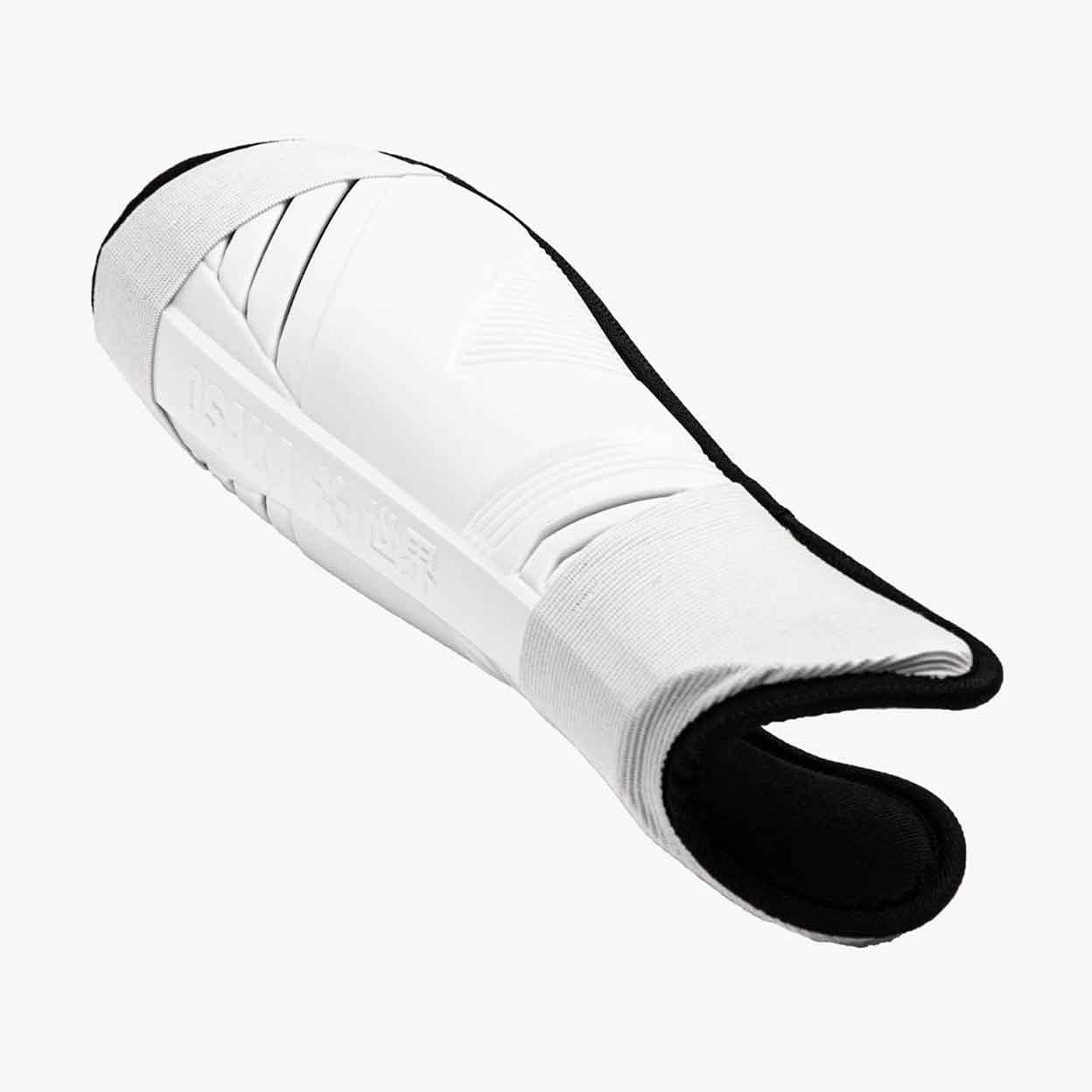 a shot of a single Osaka Field Hockey Shinguard laying down from the ankle up